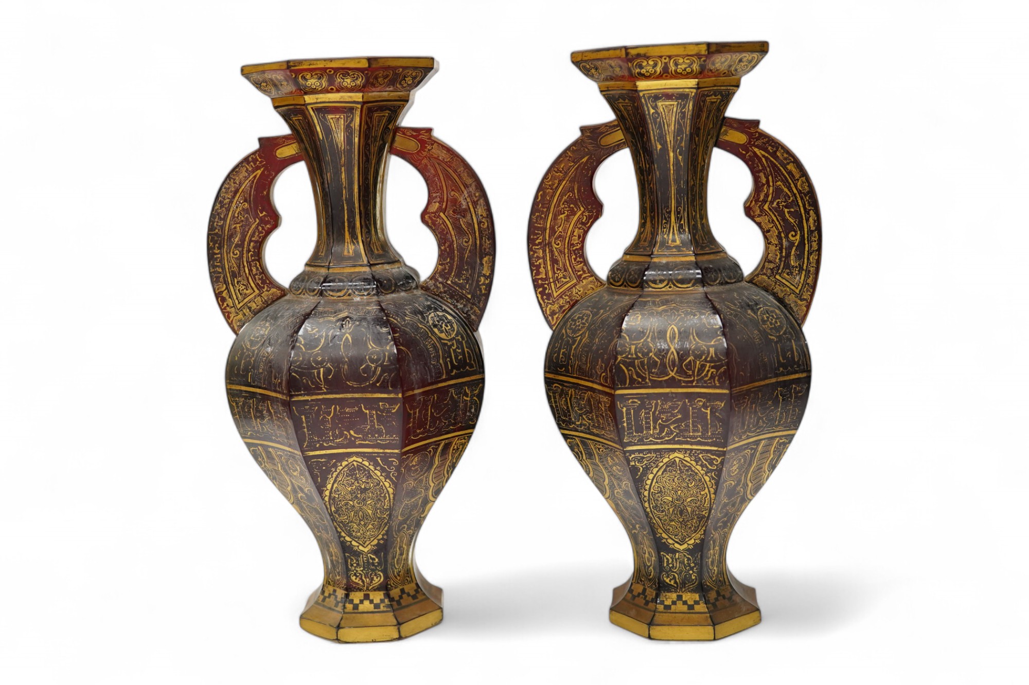 A pair of Venetian Islamic inspired gilt decorated ruby glass twin handled vases, 24cm high. Condition - wear to gilding on both vases